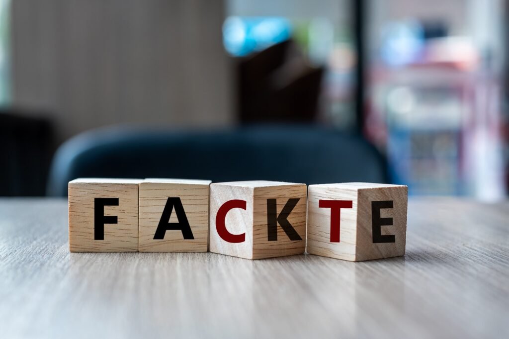 FAKE to FACT word on table background.